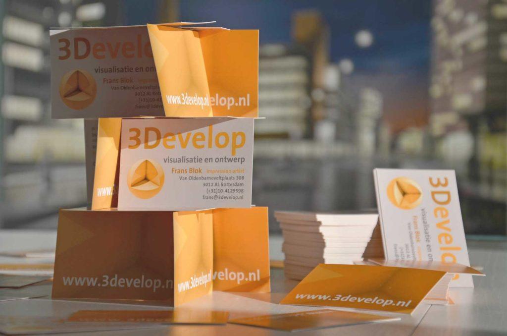 Card house constructed with the use of 3Develop business cards, with the firm's Dudok visualisation in the background