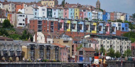 Photo of the multi-colored and rather varied architecture of Bristol, England, with the Floating Harbour in the foreground