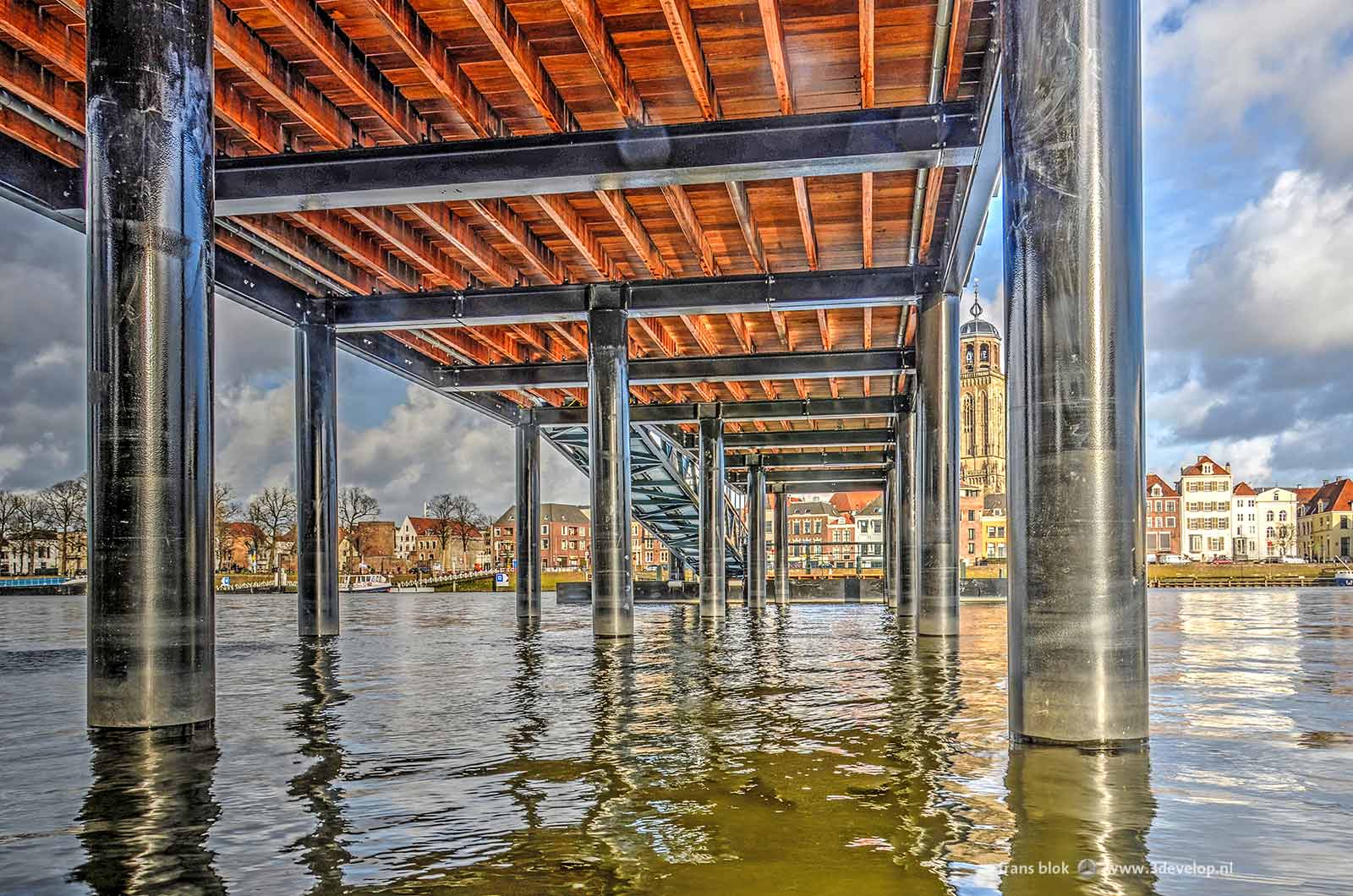 Looking under the new jetty/pontoonbridge at the Worp in Deventer with in the background the skyline of the city with Saint Lebuinus Church