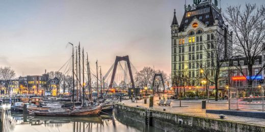 Sunrise on an almost cloudless day in Rotterdam, with Willems Bridge, the White House and the Old Harbour