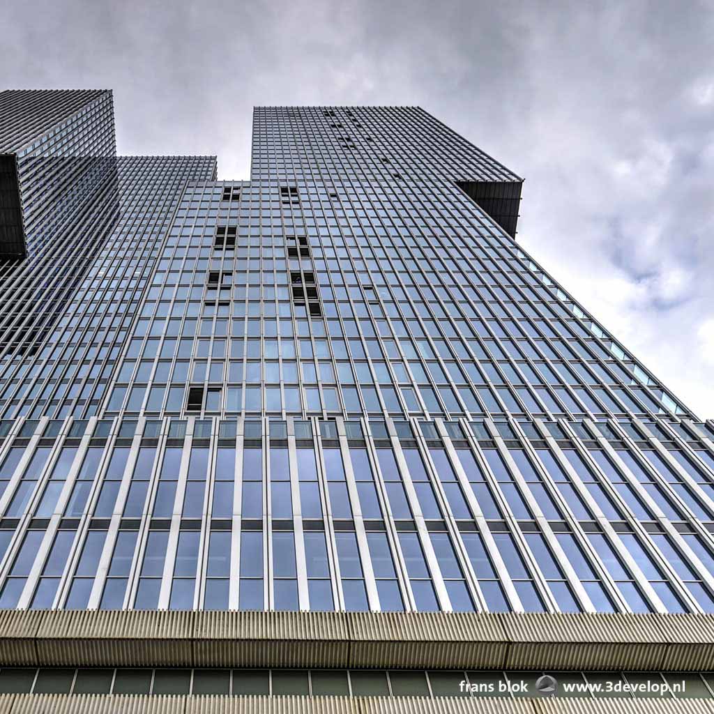 Looking up at the Rotterdam building in Rotterdam, with the open windows as an interesting detail