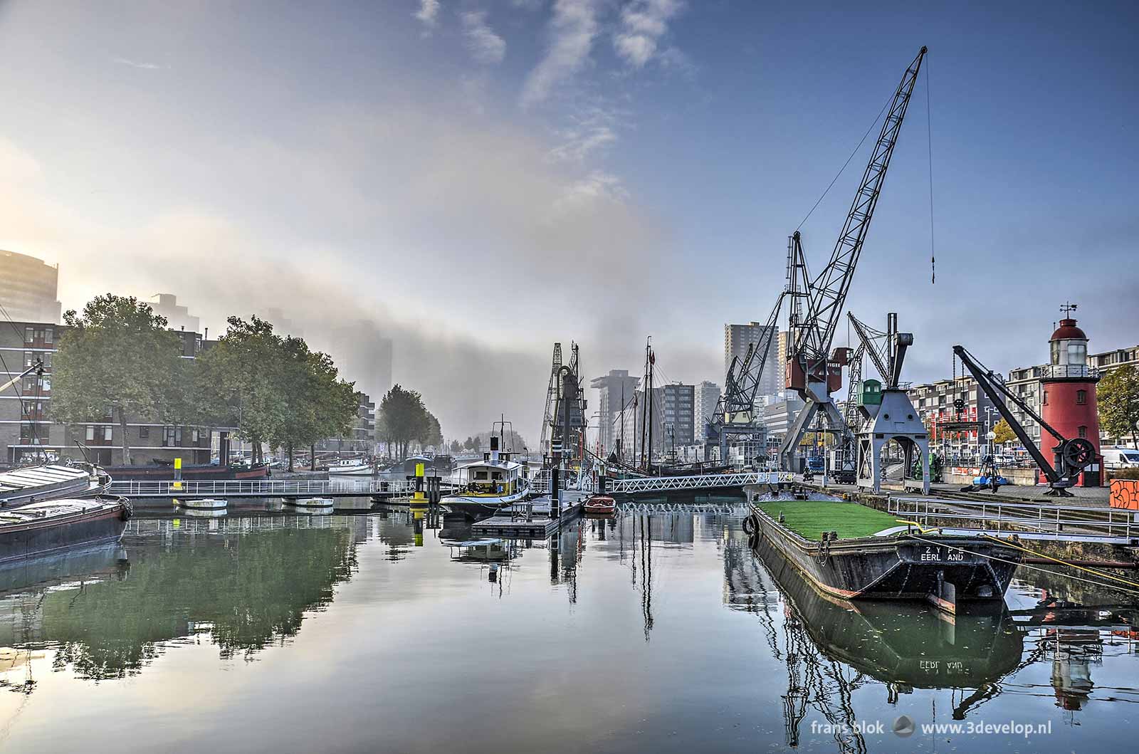 View from the quay near Maritime Museum in Rotterdam to a large volume of mist above the river Nieuwe Maas