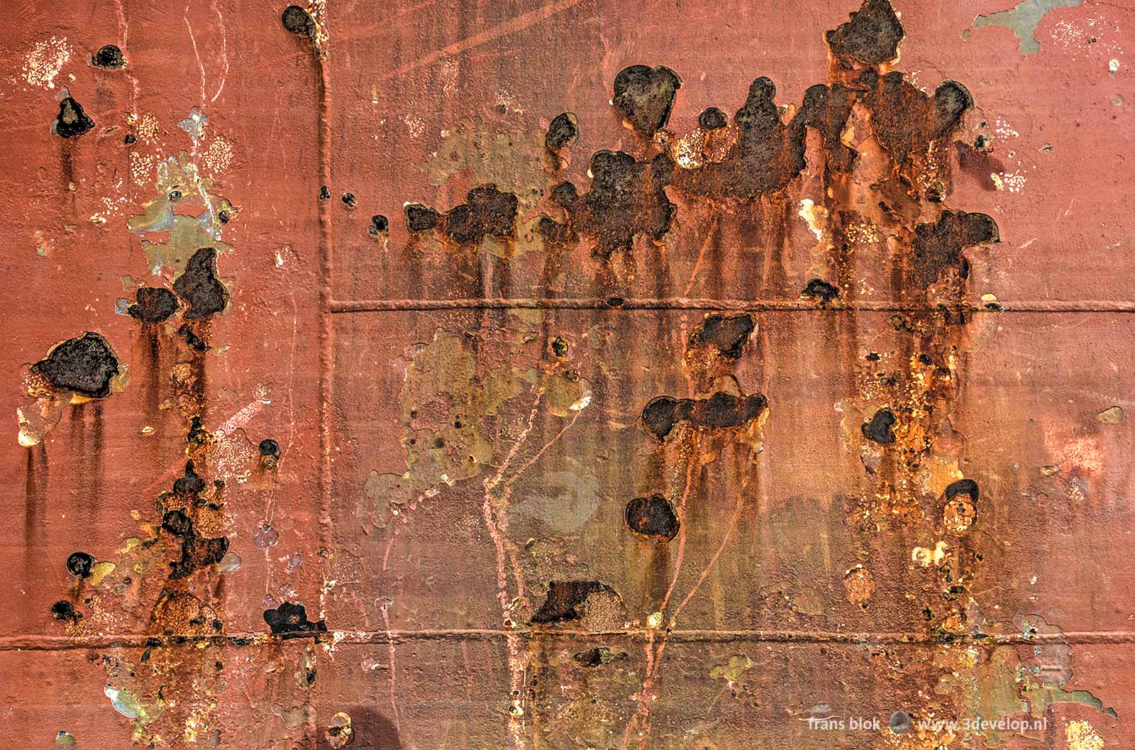 Close-up of the hull of a ship with rust and welding joints, moored at Park Quay in Rotterdam