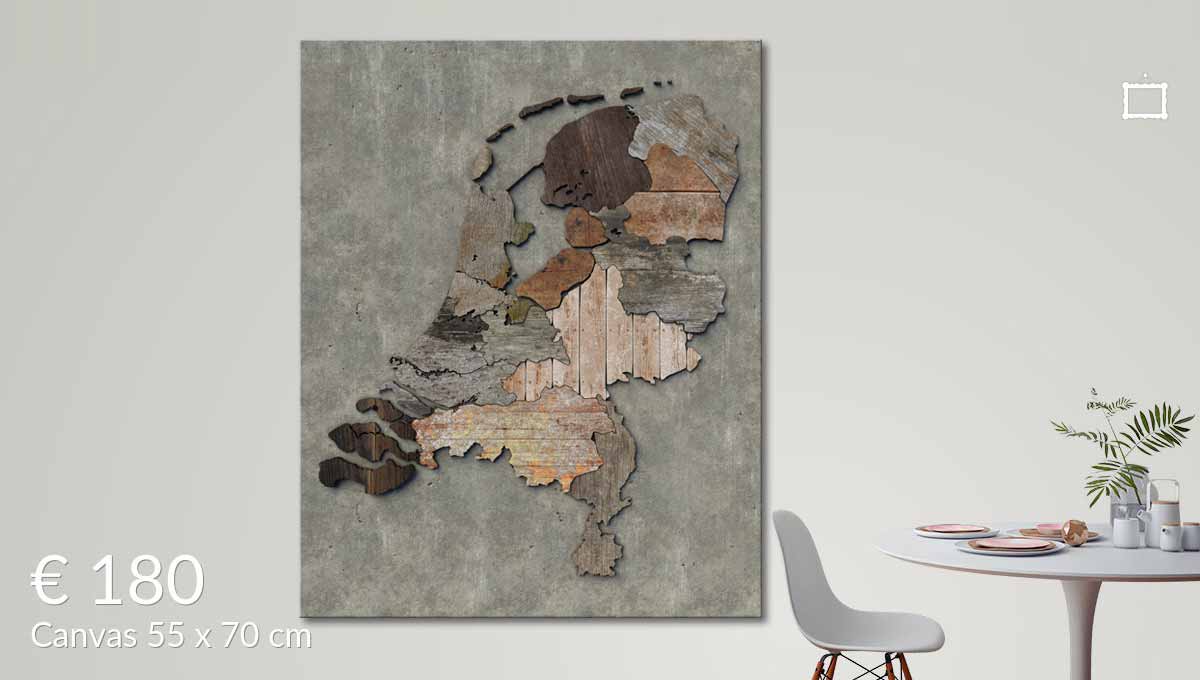 A canvasprint of the scrapwood map of the Netherlands, on the wall in a living room with a table and a chair in the foreground