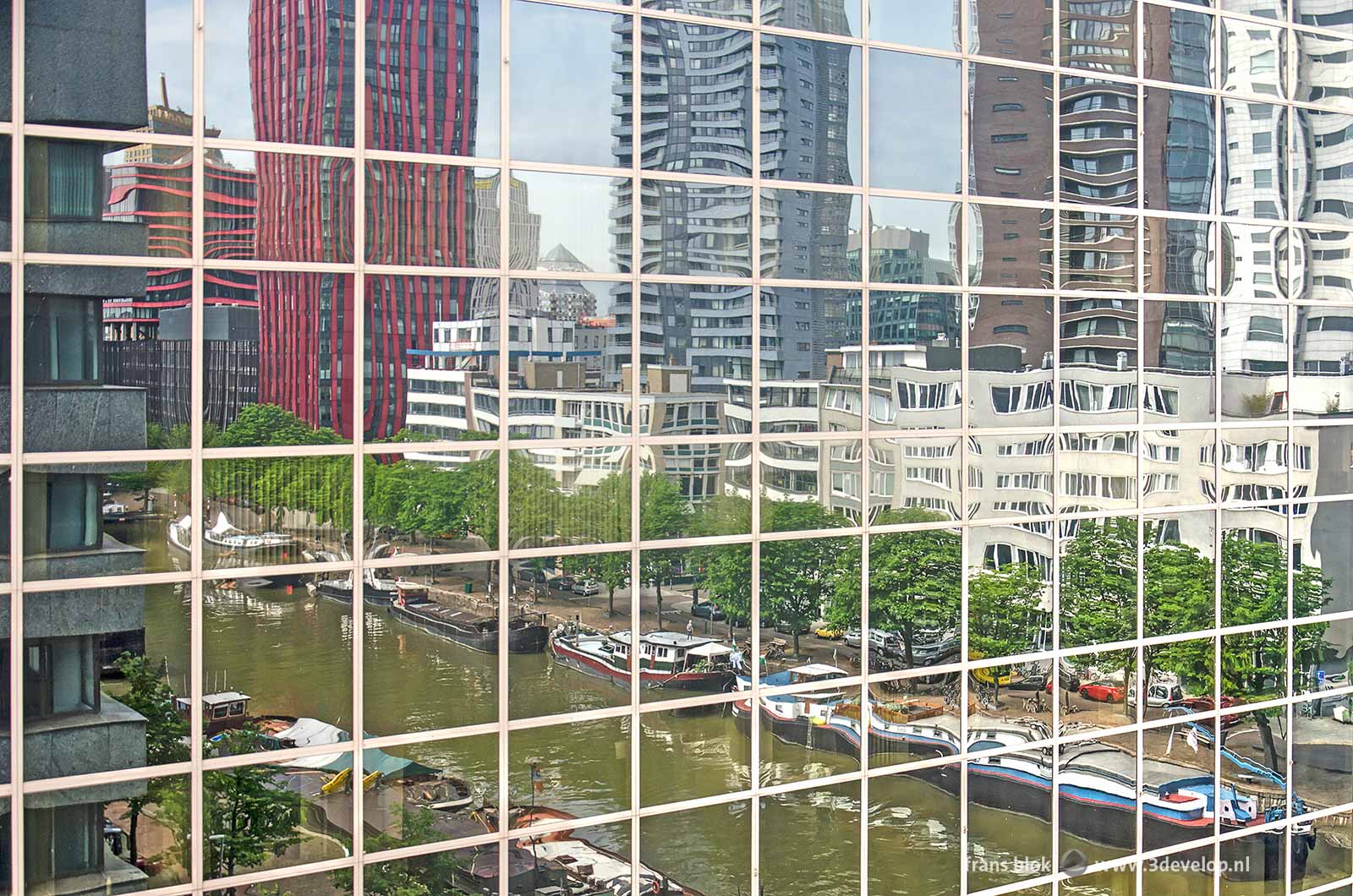 Reflection of Scheepmakershaven harbour in the glass facade of the former Pakhoed building in Rotterdam