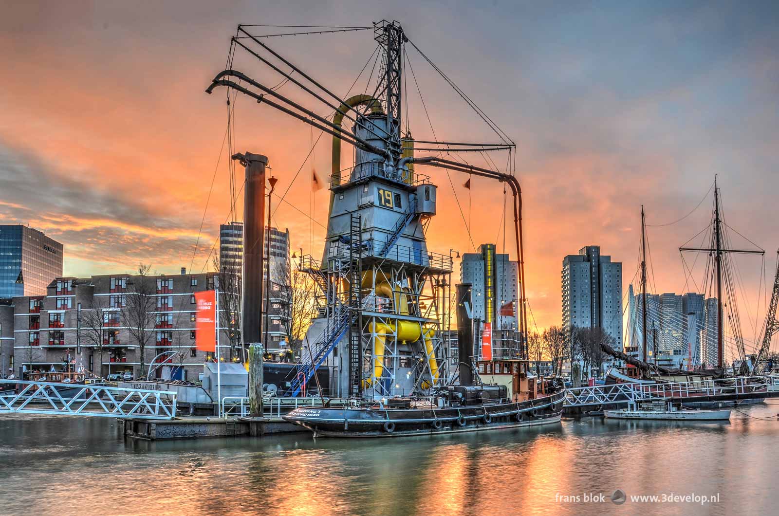 A historic grain elevator and other gems in the collection of the maritime outdoor museum in Leuvehaven harbour in Rotterdam, The Netherlands at sunrise