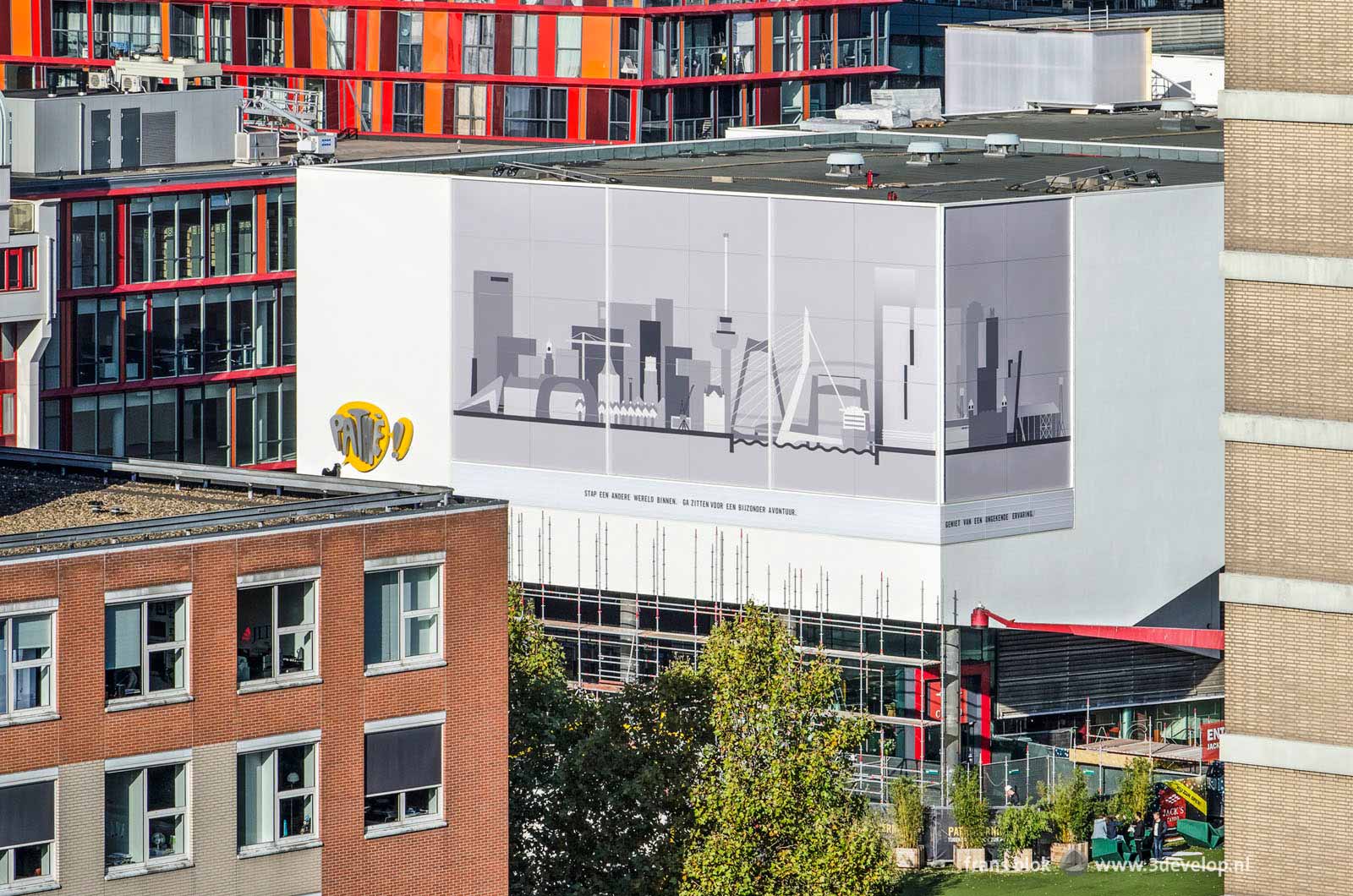 View from one of the Lijnbaan apartment buildings towards the newly renovated Pathé cinema on Schouwburgplein with the skyline of Rotterdam on the façade