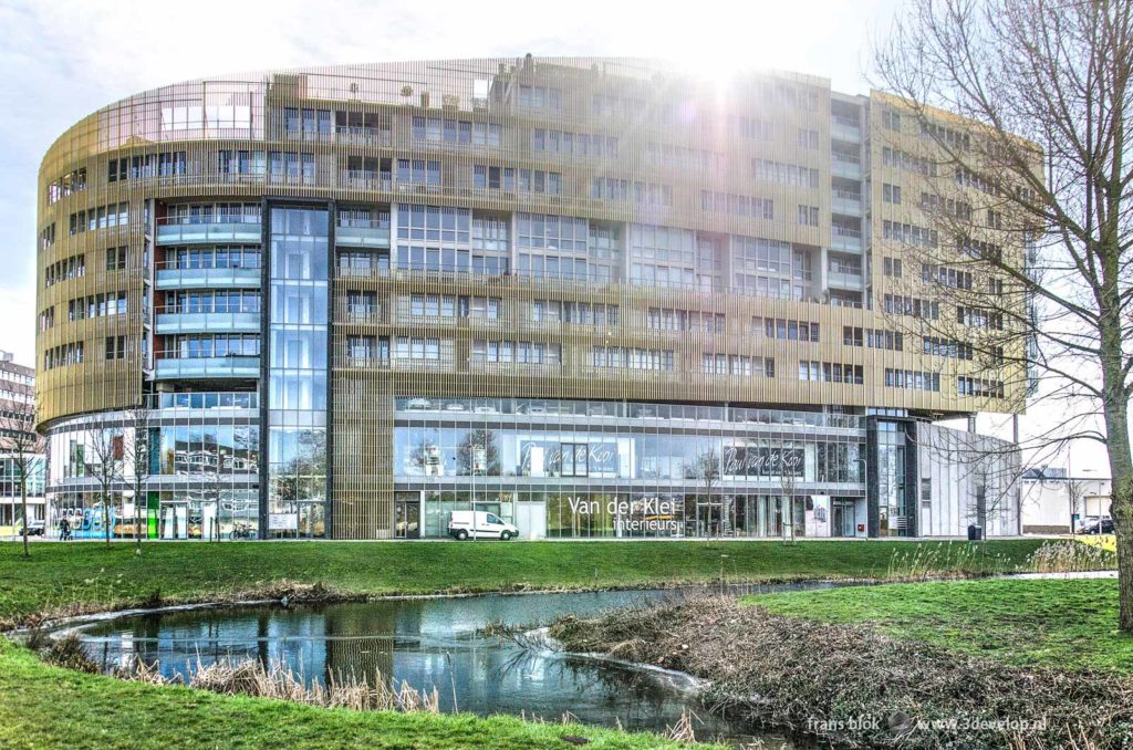 Residential building and shopping center Da Vinci in Alphen aan den Rijn, The Netherlands, with a white van parked in front of it