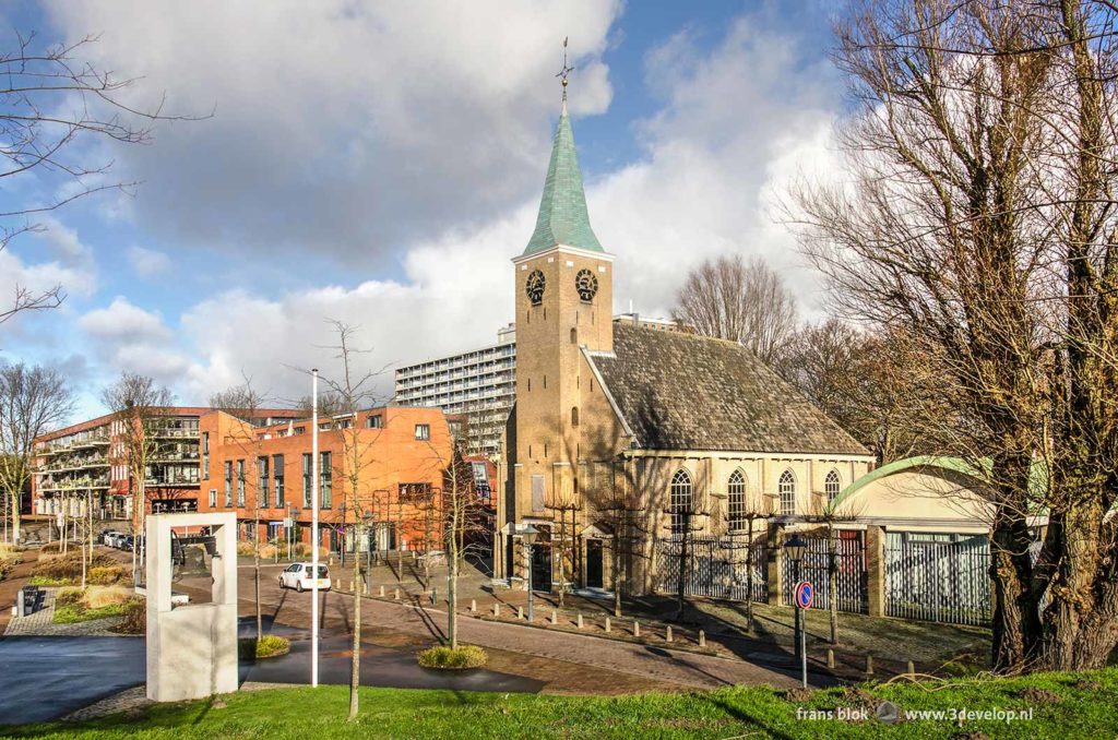 The old church of Hoogvliet with modern buildings in the background