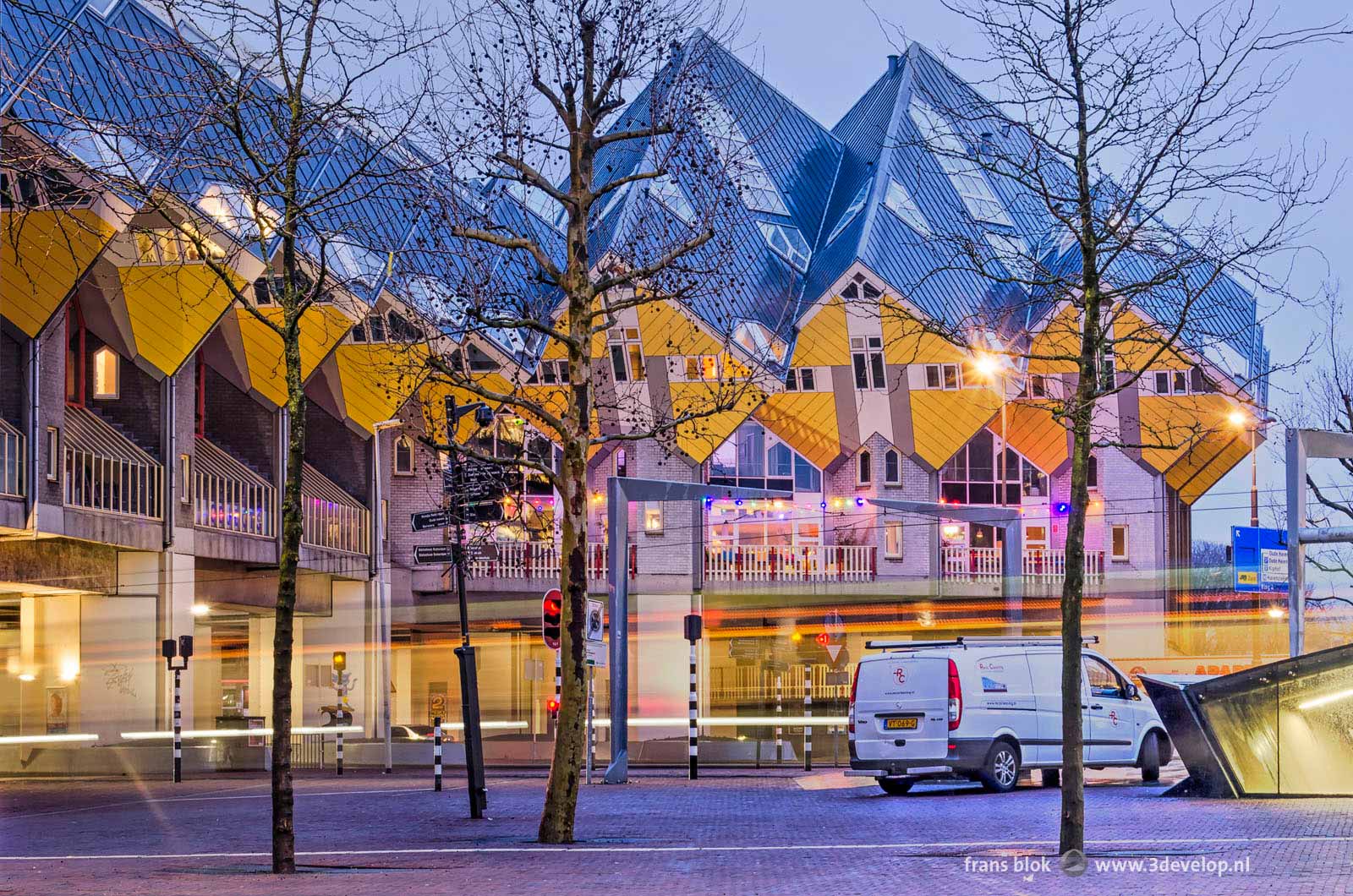 Photo made on an early winter morning of the cube houses in Rotterdam with a disfiguring white van parked in front of them