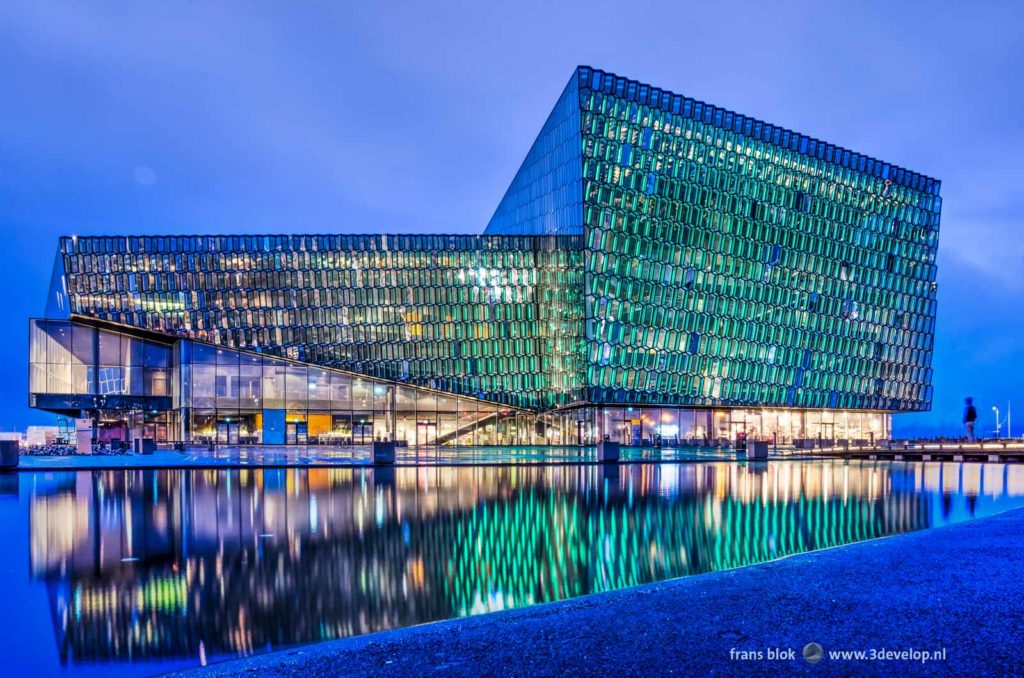 Harpa concert and congress hall in Reykjavik, Iceland, reflecting in a pool during the blue hour after sunset