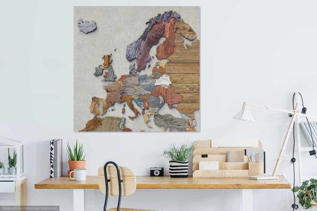 The scrapwood map of Europe as decoration on a wall in a modern room over a wooden desk