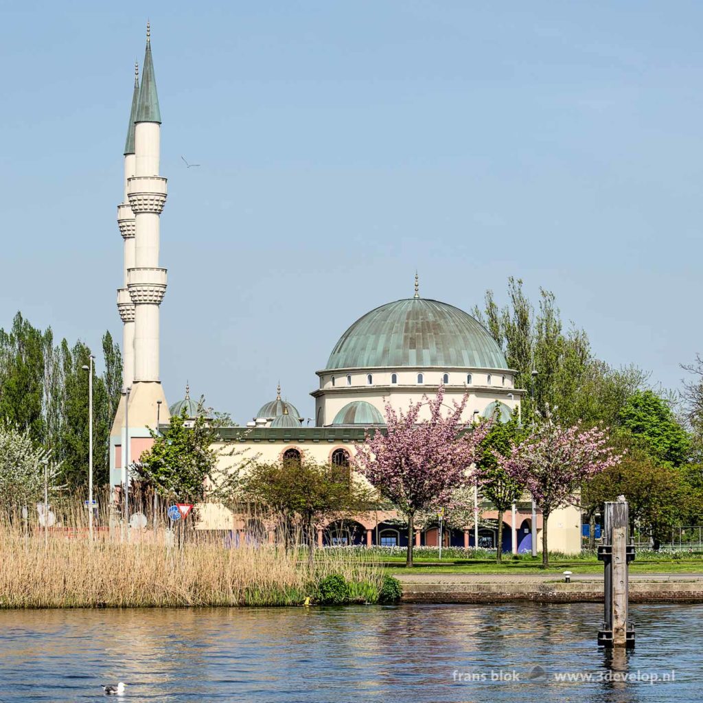 The Mevlana mosque in Rotterdam in springtime with the Schie river in the foreground