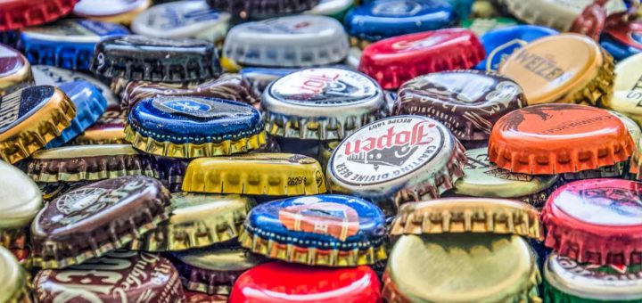 Close-up of a colorful pile of crown caps from beer bottles