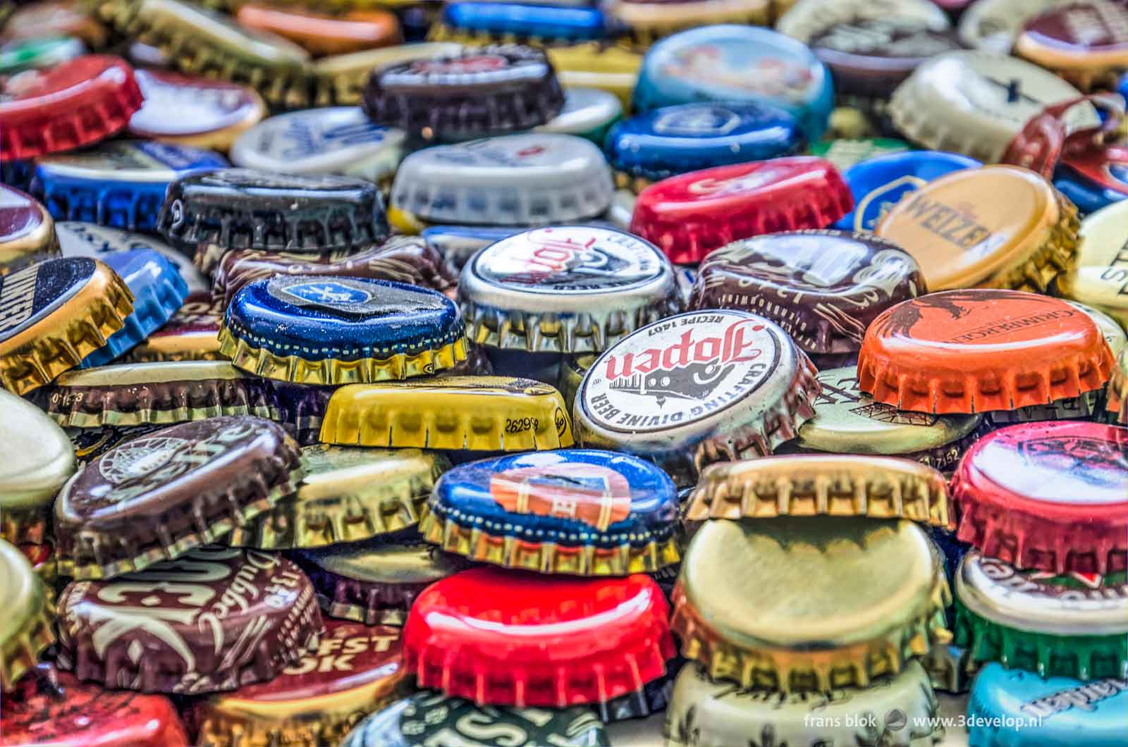 Close-up of a colorful pile of crown caps from beer bottles