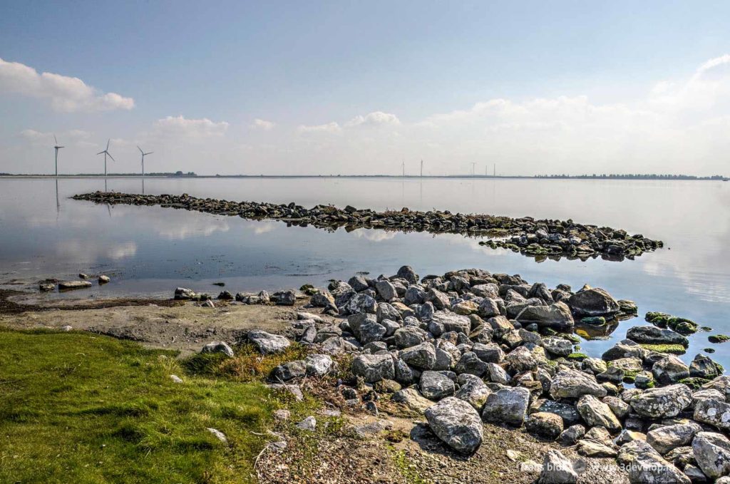 Beach with sand, grass and rocks near Herkingen, The Netherlands, as seen during a long distance hike around Lake Grevelingen