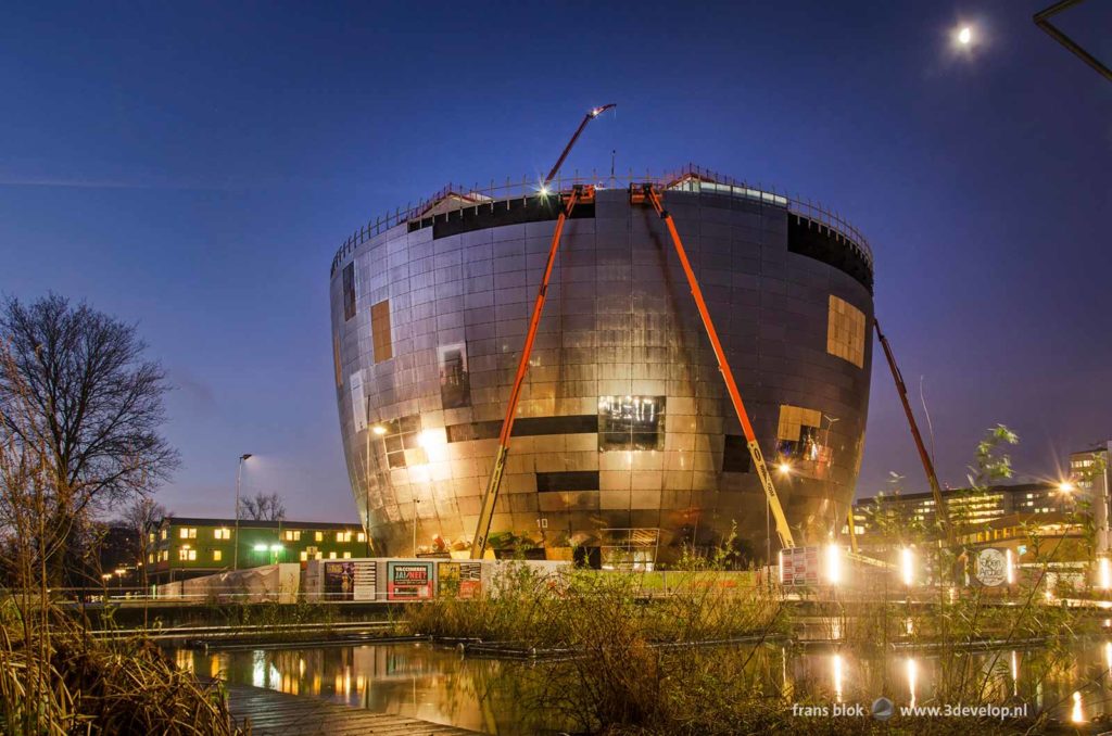 The shining pot of the Boymans museum collection building under construction in Museum Park in Rotterdam during the blue hour on a morning the the winter of 2020