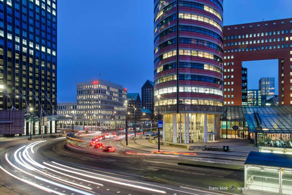 Morning rush hour at Kop van Zuid district in Rotterdam, surrounded by modern architecture, during the blue hour on a January morning