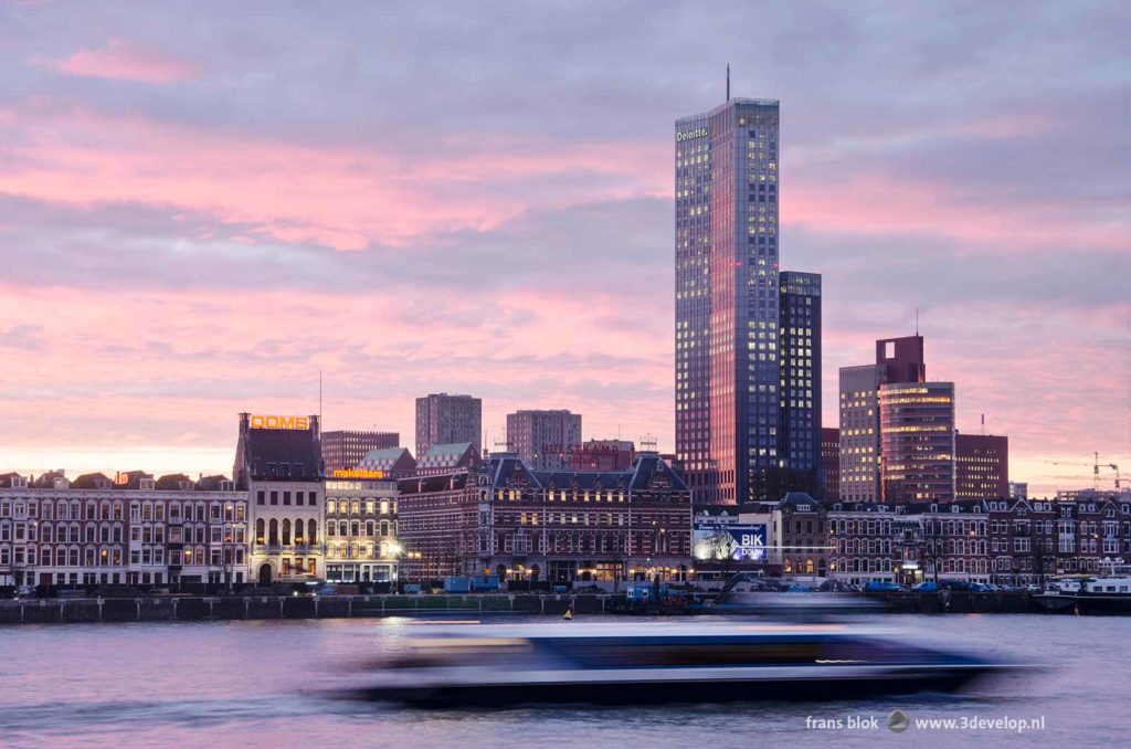 Dawn at the Nieuwe Maas river in Rotterdam, with the Maas tower, Noordereiland and a fast moving Waterbus