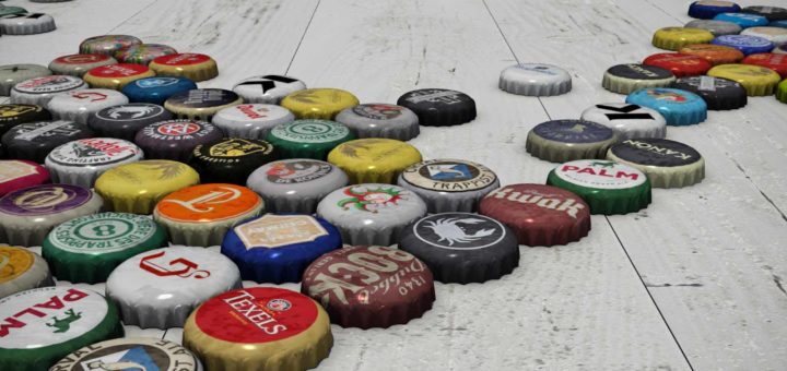 Close-up of a large number of bottle caps of Belgian and Dutch beers on a white wooden floor, together making a world map