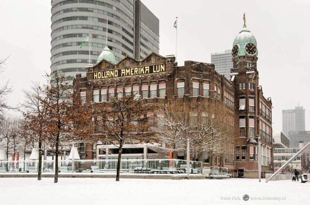 Hotel New York on Wilhelminapier in Rotterdam, surrounded by and covered under a layer of fresh snow in the winter of 2021