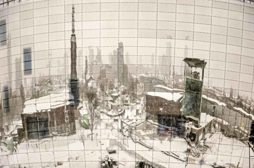 The city of Rotterdam, covered with snow in the winter of 2021, reflecting in the mirror facade of the new depot of the Boymans museum