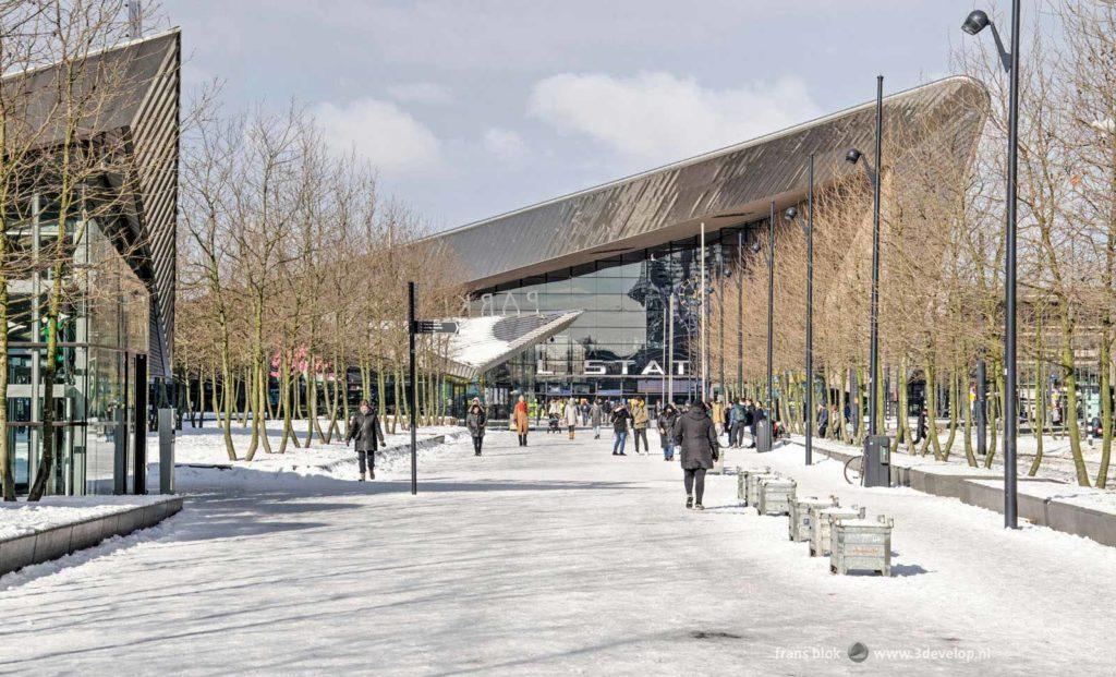 Kruisplein square in Rotterdam, covered with compact snow and in the background the Central Station on a sunny day in the winter of 2021