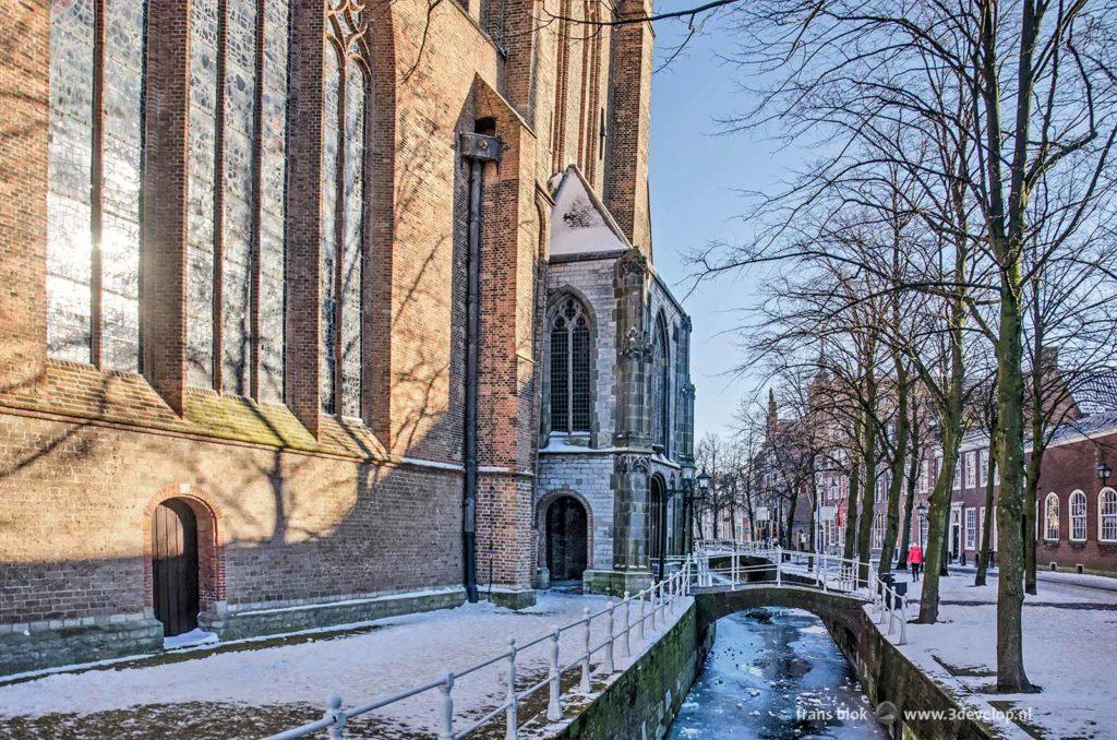 Old Delft Canal and the Old church in Delft, the Netherlands on a sunny day in winter