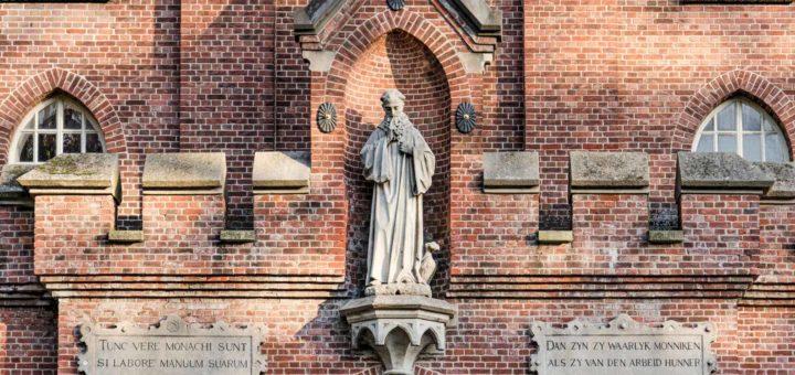 Detail of the Koningshoeven abbey near Tilburg, The Netherlands, with statue and proverbs