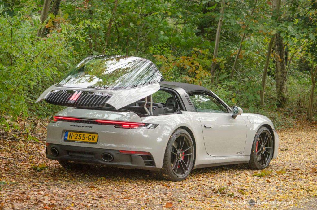 Porsche 992 Targa 4 GTS with opning rear section on a clearing in the forest