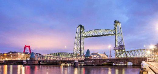 Koningshaven harbour, railway bridge De Hef and Noordereiland neighbourhood in Rotterdam, The Netherlands during the blue hour on a winter morning