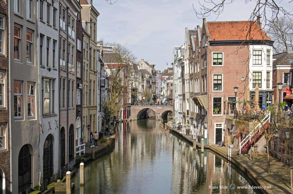 The Old Canal in Utrecht, the Netherlands, meandering between historic houses on a sunny day in spring