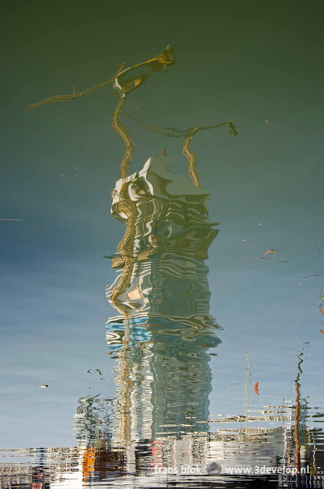 Reflection of the Cool Tower, under construction, in the water of Leuvehaven harbour in Rotterdam, The Netherlands