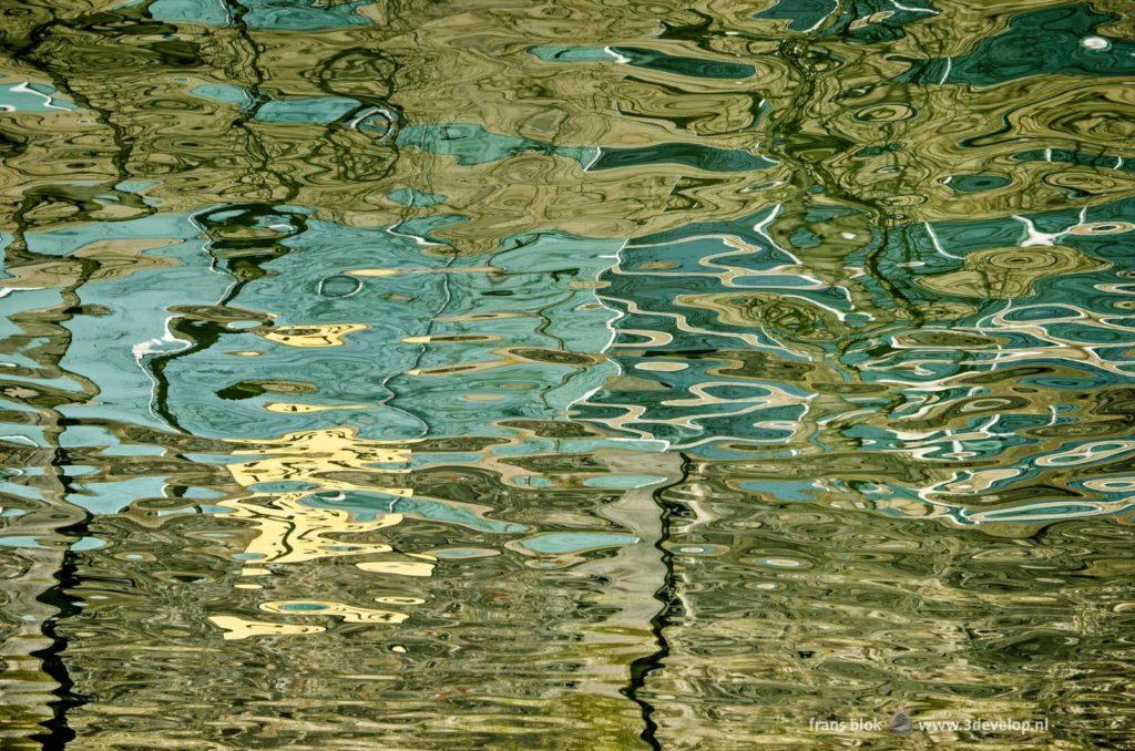 Abstract image, created by the reflection of a quay wall and the adjacent building in the water of Rijnhaven harbour in Rotterdam, The Netherlands