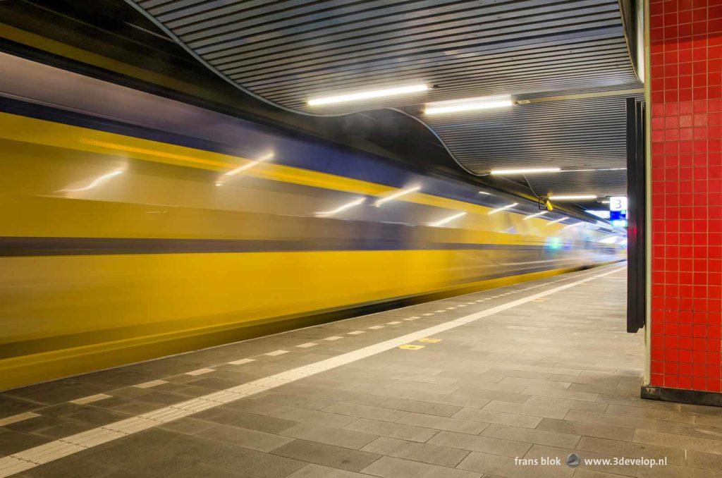 A train rushes by at railway station Rotterdam-Blaak, Holland