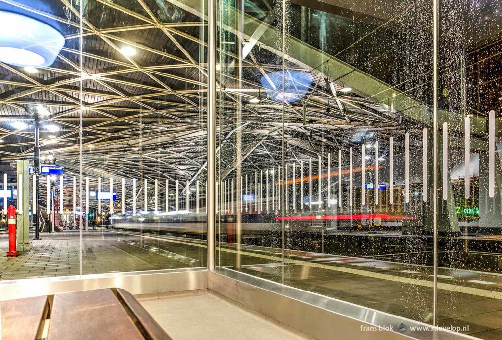 Waiting room in the railway station at Tilburg, the Netherlands, while a train passes by