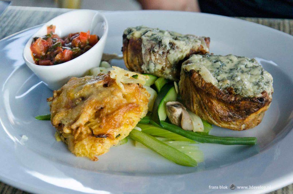 White plate with a vegetarian dish with aubergine and blue cheese