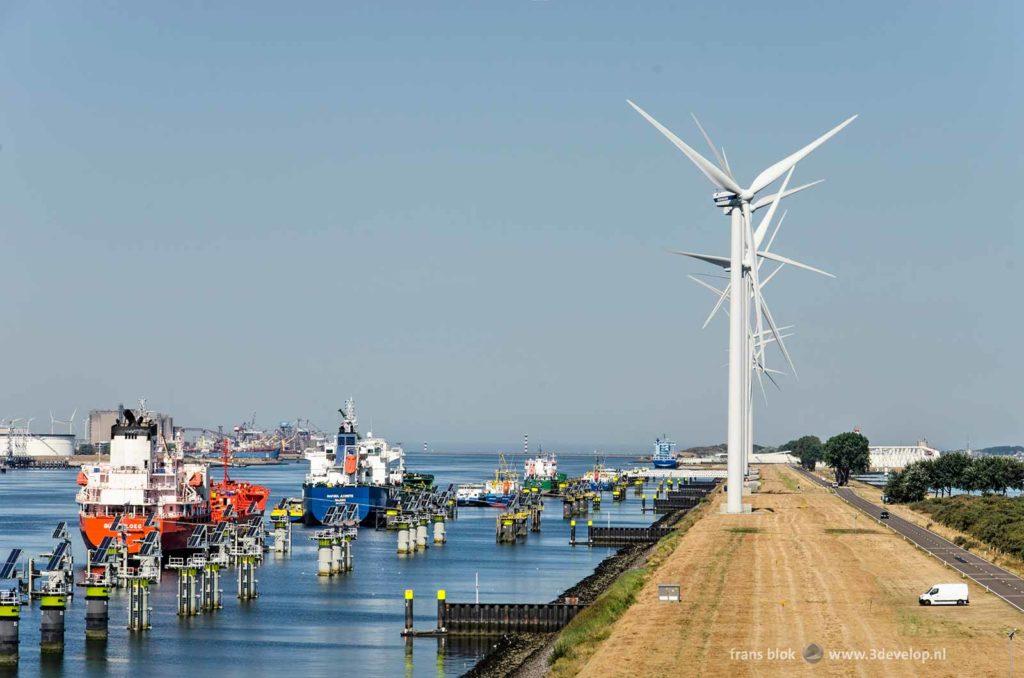 Rozenburg peninsula in Rotterdam, the Netherlands, seen from viewing point Paal 83, with ships, wind turbines, sea barrier and a white van