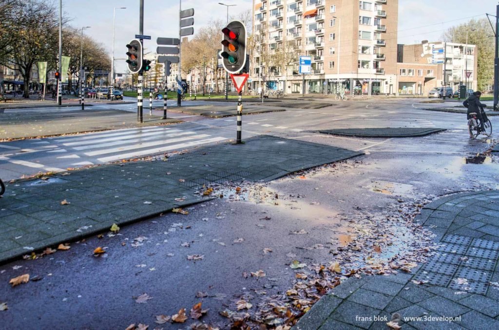 Pavement tiles and asphalt at the junction of goudsesingel and Mariniersweg in downtown Rotterdam