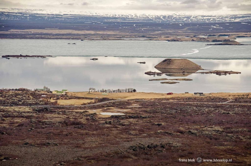 Lake Myvatn, partly frozen, with pseucrater on a day in spring, seen from the rim of Hverfall crater, number one in the top 10 of best photos of 2022