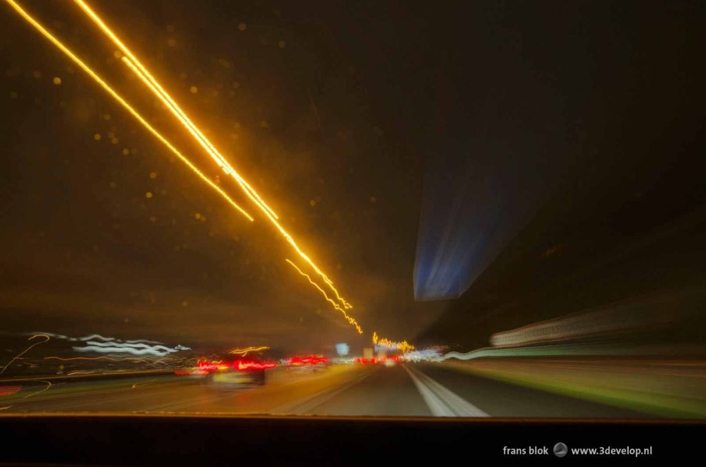 Image made from the dashboard in a driving car on the highway with a long exposure