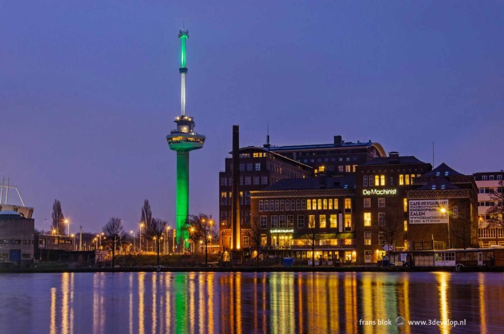 Euromast, Puntegale and Machinist reflecting in the water of Coolhaven harbour on a blue monday before sunrise