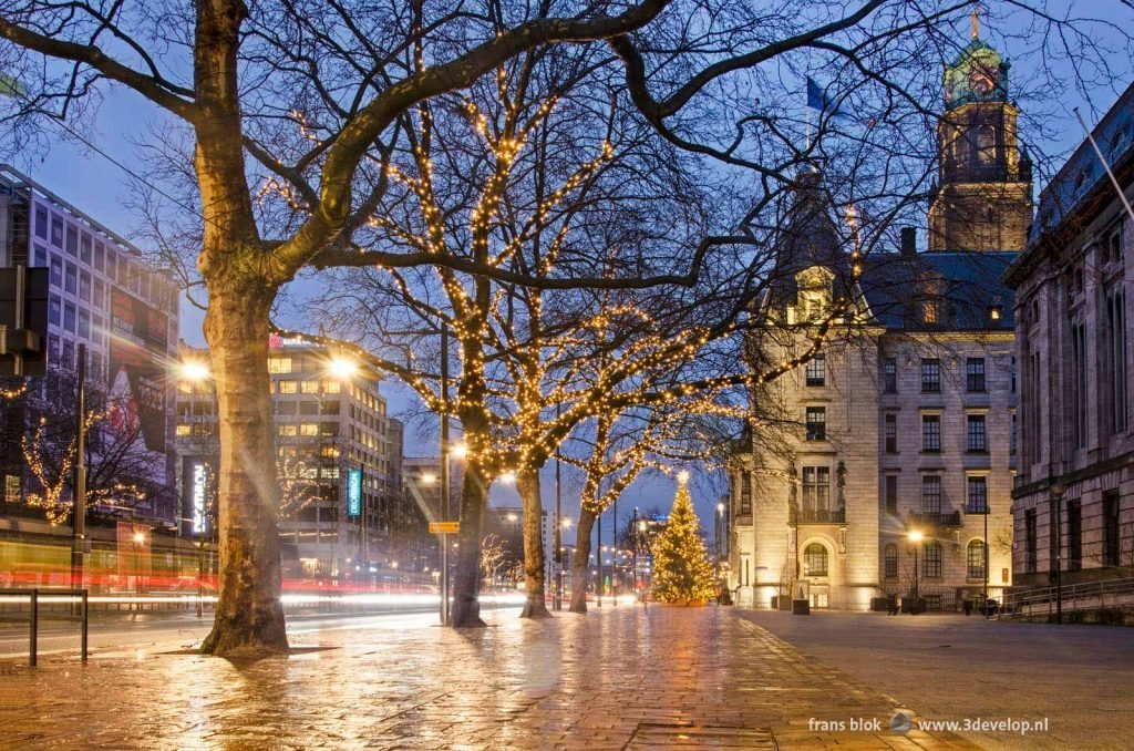 Coolsingel boulevard in Rotterdam with Christmas lights near the town hall on a rainy morning in january