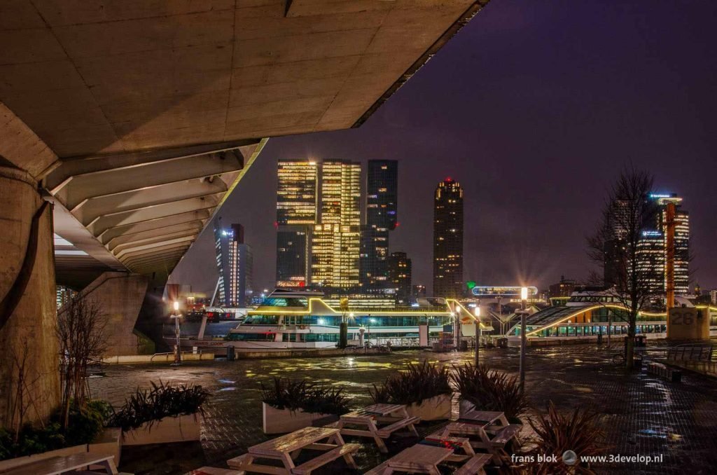 The Spido tour boats, the Southbank developments and the underside of Erasmus bridge in Rotterdam on a rainy morning before sunrise