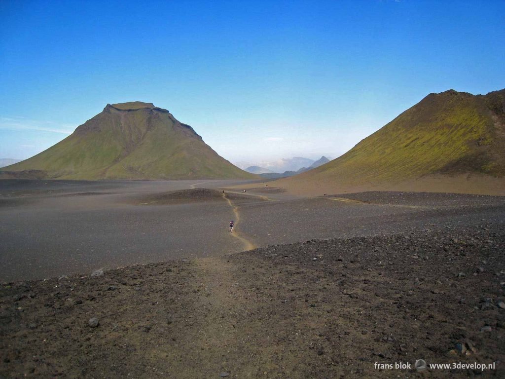 Black plains, green mountain slopes and blue sky at the Laugavegur trek in Iceland