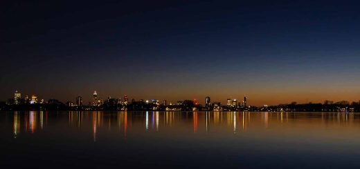 Conjunction of the planets Venus and Jupiter above lake Kralingse Plas in Rotterdam with the city's skyline in the background