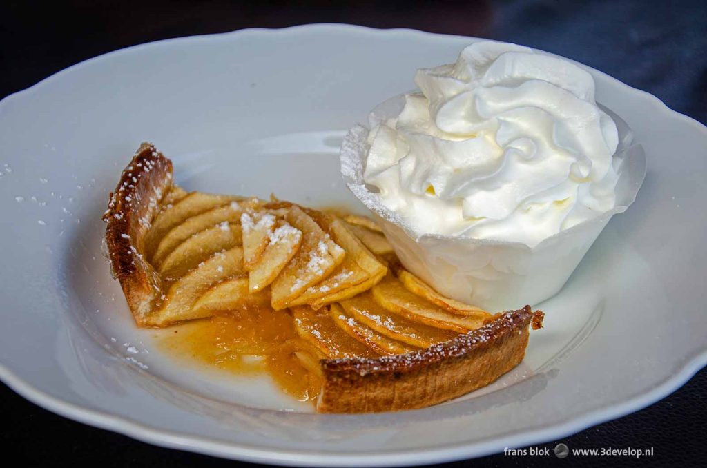 Warm apple pie with whipped cream on a Belgian terrace