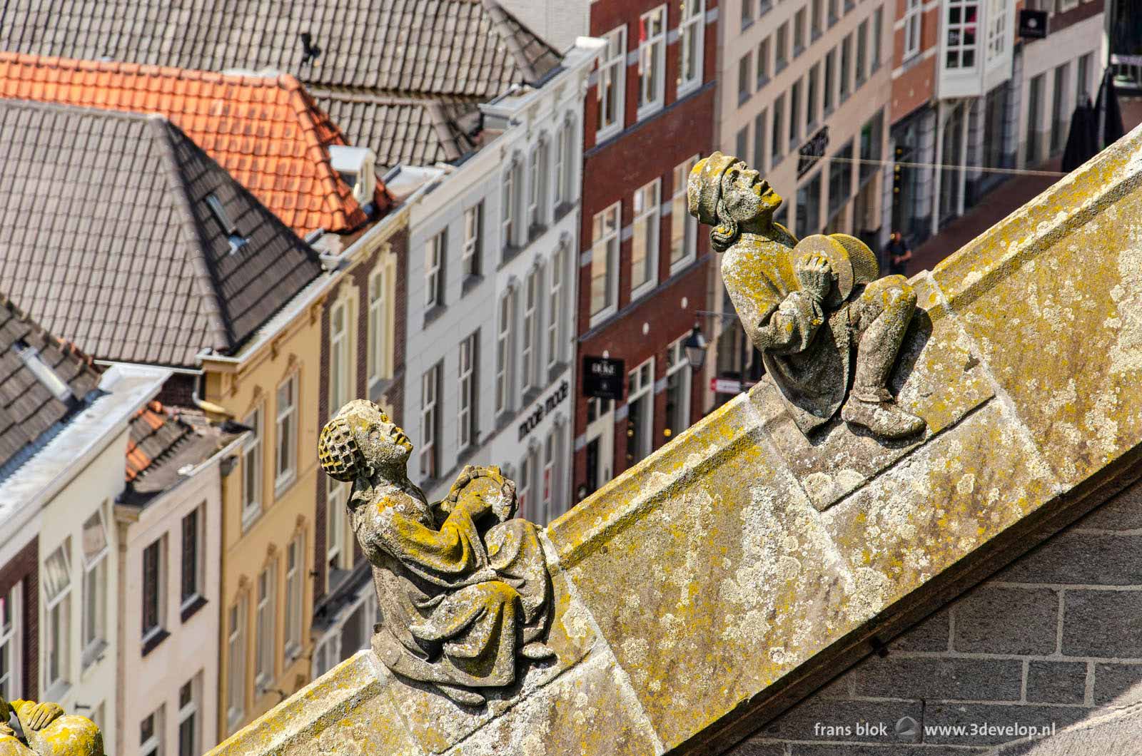 Two of the many sculptures of craftsmen on Saint John's cathedral in Den Bosch, The Netherlands