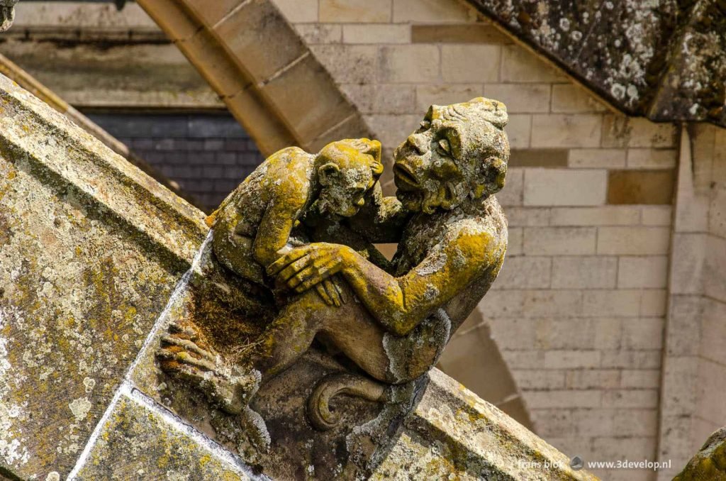 Sculpture with two figures on a support structure on Saint John's cathedral in Den Bosch, The Netherlands