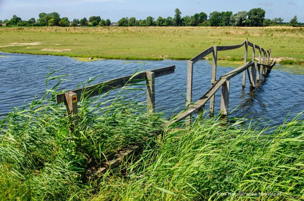 Very ramshackle wooden bridge for hikers across a creek on the Dutch island of Voorne